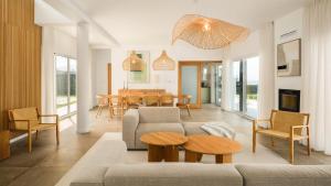 a living room with a couch and a table at Casa do Mar - North Coast Ocean Views in Calhetas