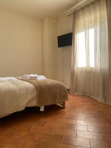 a bedroom with a bed and a large window at Casa Rasiglia 2 House Smart in Casenove
