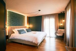 a bedroom with a bed and a chair and a window at Oklm6 in Mellet