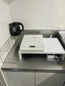 a washing machine sitting on top of a counter at イマココホテル in Yogi