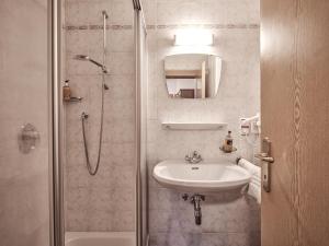 a white bathroom with a sink and a shower at Fermeda in Villnoss
