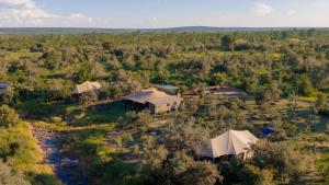 an aerial view of a group of tents next to a river at Mutsviri Game Lodge in Victoria Falls