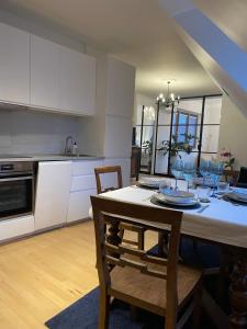a kitchen and dining room with a table and chairs at Amadeus Studio in Baden