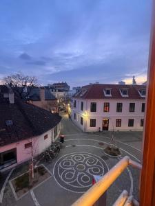 a view from a balcony of a street with buildings at Amadeus Studio in Baden