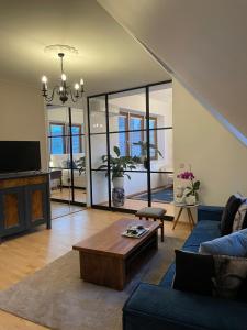 a living room with a couch and a table at Amadeus Studio in Baden