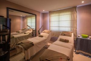 a hospital room with several beds and a mirror at Dar Khayam in Hammamet