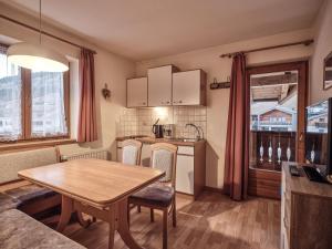 a kitchen and dining room with a table and chairs at Fermeda in Villnoss +18 photos