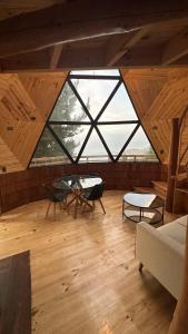 a large room with a large window and a table at Villa Santa Rita in Cobquecura