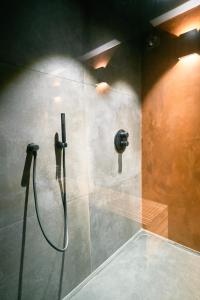 a shower stall in a bathroom with a hose at Oklm6 in Mellet +29 photos
