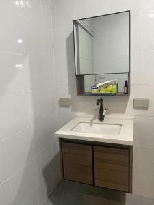 a bathroom with a sink and a mirror at Joyful House in Ban Dan