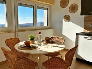 a kitchen with a white table with chairs and a table and a table at Il Colle in Buia
