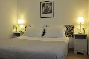 a bedroom with a large bed with white pillows at Cà du Ferrà - Farm and Relax in Bonassola