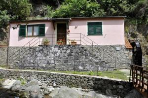 a house on top of a stone wall at Cà du Ferrà - Farm and Relax in Bonassola