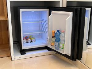 an open refrigerator with bottles and drinks in it at B&B Affittacamere Vecchia Alimini in Otranto