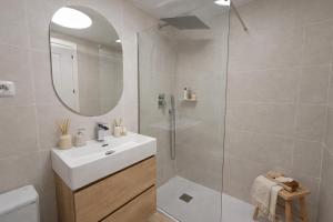 a white bathroom with a sink and a shower at Noctua Duquesa Beach 009 in Manilva +4 photos