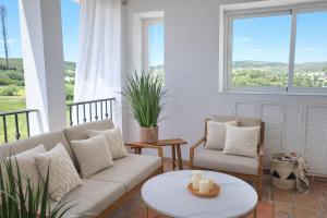 a living room with a couch and a table at Noctua Duquesa Beach 009 in Manilva