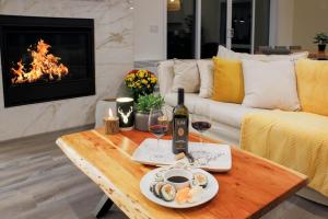 a living room with a table with wine and wine glasses at Chalet Boréale with Private Spa & Billiards, Golf & Carling Lake in Brownsburg +46 photos