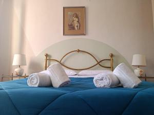 a blue bed with towels on top of it at Casa dell' Onda 25 in Siena
