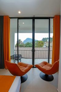 a bedroom with a bed and a balcony with a view at Sun Top Grand in Ella