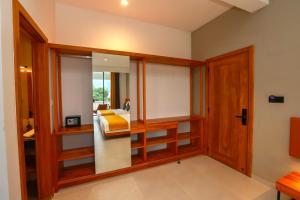 a room with wooden shelves and a bed in it at Sun Top Grand in Ella