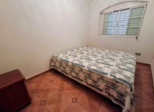 a bedroom with a bed in a room with a window at Espaço da Iza in São Pedro