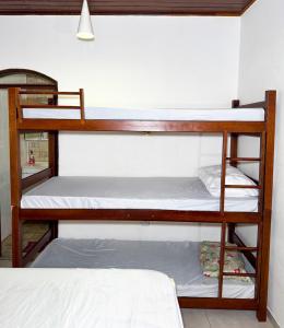 a couple of bunk beds in a room at Ilhabela quarto próx praia in Ilhabela +14 photos