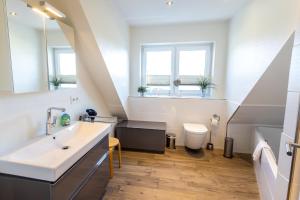 a bathroom with a sink and a toilet at Doppelhaushälfte Op de Geest in Böhl +38 photos