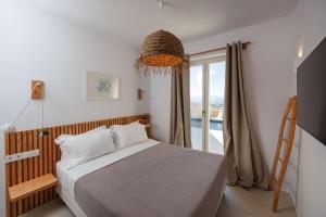 a bedroom with a bed and a large window at Arcadia Naxos in Naxos Chora +48 photos