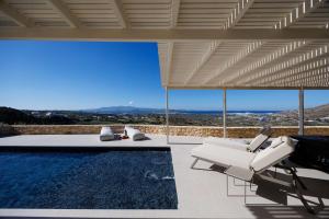 a villa with a swimming pool and a house at Arcadia Naxos in Naxos Chora