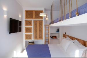 a bedroom with a bed and a tv on a wall at Arcadia Naxos in Naxos Chora