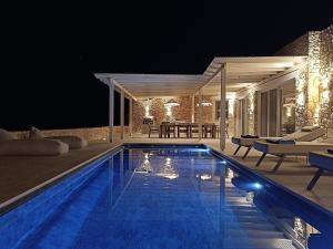 a swimming pool in front of a house at night at Arcadia Naxos in Naxos Chora