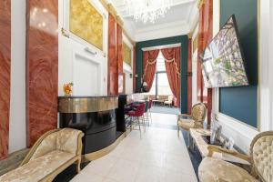 a living room with a bar and chairs at Hotel Praga 1885 by Wagnerstays in Prague +82 photos