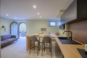 a kitchen with a island with chairs and a table at 1029 GuestHouse in Sora