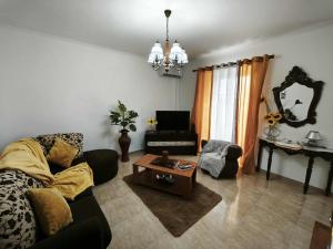 a living room with a couch and a coffee table at Arco-Iris in Santo António