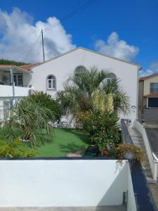 a view from the balcony of a house with a yard at Arco-Iris in Santo António