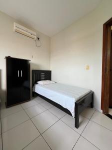 a bedroom with a bed and a air conditioner at Hotel Brilhante 2 in Itacarambi