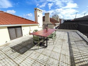 a wooden table and chairs on a patio at Alenquer, Alojamento Santa Catarina in Alenquer