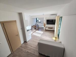 a white living room with a couch and a living room at Srce Fojnice in Fojnica +18 photos