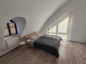 a bedroom with a bed and a large window at Srce Fojnice in Fojnica