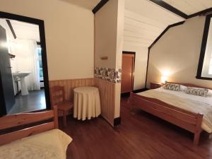 a bedroom with a bed and a table in it at Hostal Los Riscos in Llanquihue +4 photos