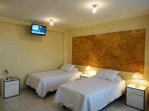 Voodi või voodid majutusasutuse HOTEL MAISON FIORI (Centro) toas