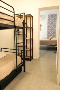 a room with bunk beds and a room with a mirror at Saludu Boutique in Porto Torres