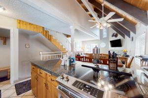 a kitchen with a ceiling fan and a staircase at Mammoth View Villas 30 in Mammoth Lakes