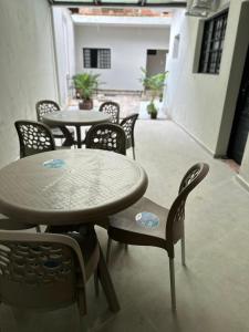a group of tables and chairs in a room at Hotel Pousada Romanos in Aparecida