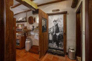 a hallway with a door with a picture on the wall at Antiga Fábrica da Manteiga by An Island Apart in Arco da Calheta +27 photos