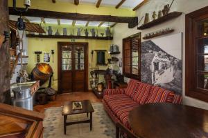 a living room with a couch and a table at Antiga Fábrica da Manteiga by An Island Apart in Arco da Calheta
