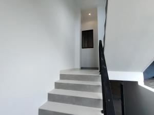 a staircase in a house with white walls at Calvian Villa in Walliwala East