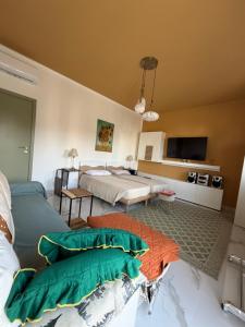 a bedroom with two beds and a television in it at Apartment Rino 1 Caorso in Caorso