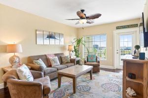 a living room with a couch and a table at Splash Harbour, Harbourside Waterfront Condo in Clearwater Beach