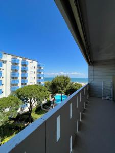 a balcony of a building with a view of the ocean at Residence Luna in Lignano Sabbiadoro